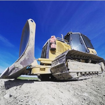 Site grading equipment preparing a building pad